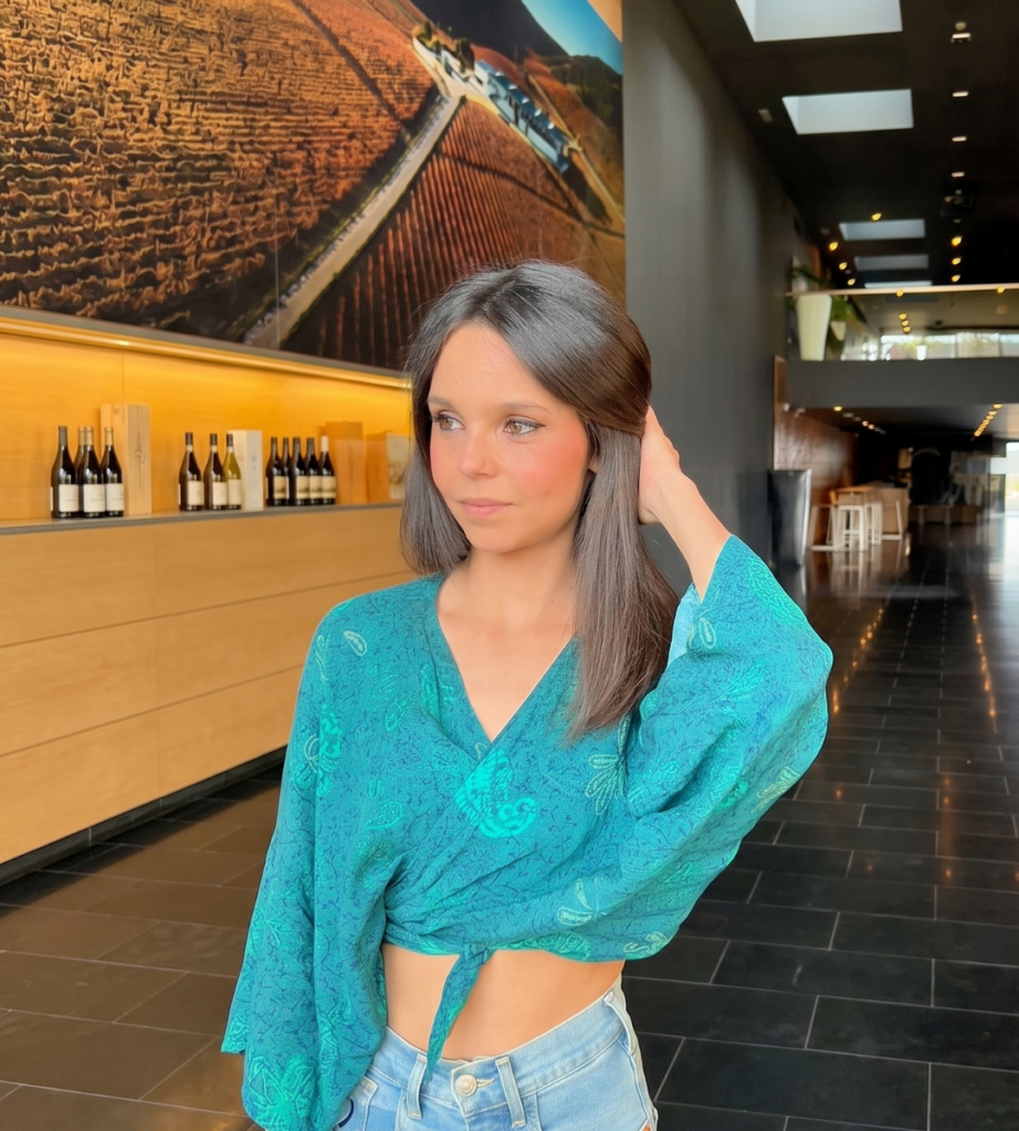 Ylenia Peláez posando en el exterior de un edificio con un conjunto verde.