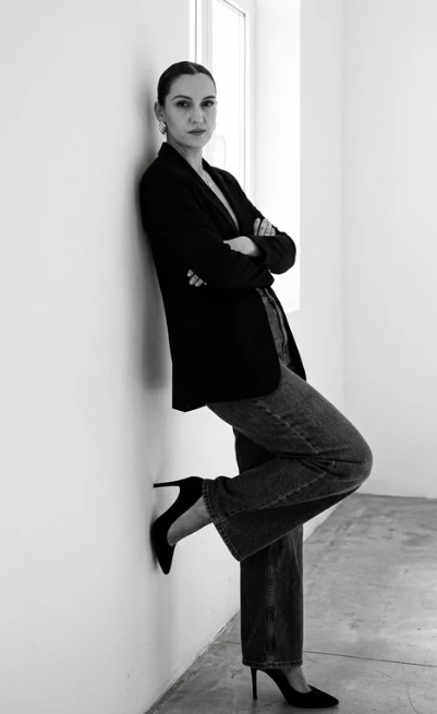 Nerea López, creadora de UGC, retrato profesional en blanco y negro con blazer negro y pantalón gris, mostrando confianza y creatividad.