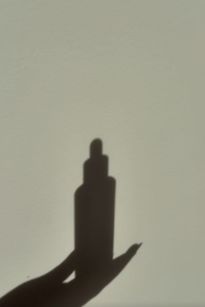 Silueta de un producto cosmético sostenido por una mano para contenido de belleza, skincare y Lifestyle.
