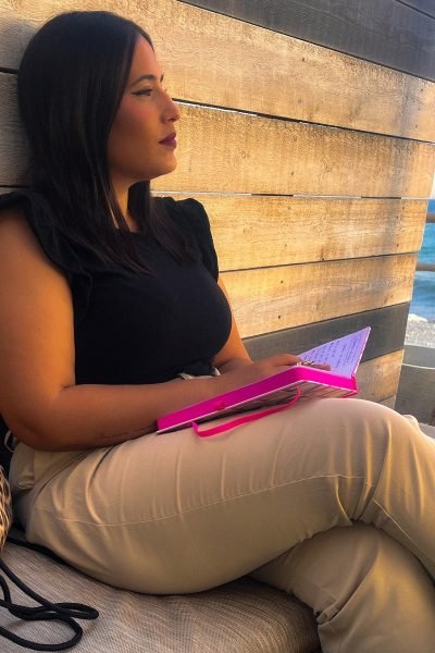 UGC Marta Salado Sánchez escribiendo junto al mar para contenido Lifestyle y productividad – Agencia Brilla.