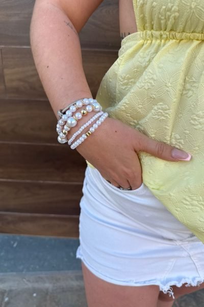Miriam Castellote mostrando sus accesorios de pulseras y bolso.