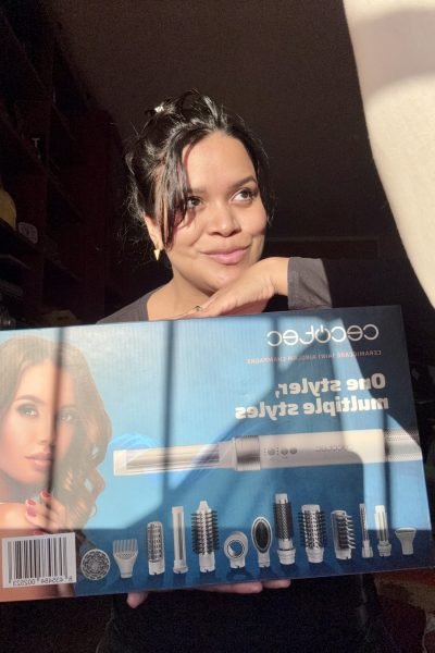 Mercedes Vergara sonriente mostrando el set de accesorios de peinado Cecotec con varias boquillas y cepillos.